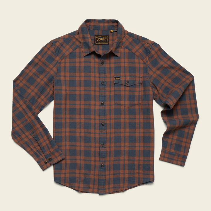 Howler Brothers plaid shirt with brown and blue pattern on a beige background