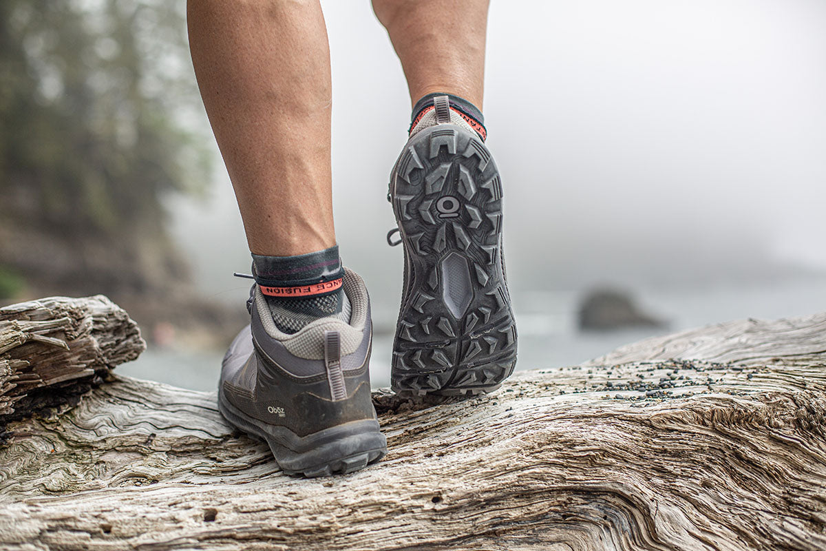 A person walking in Oboz hiking shoes on a trail