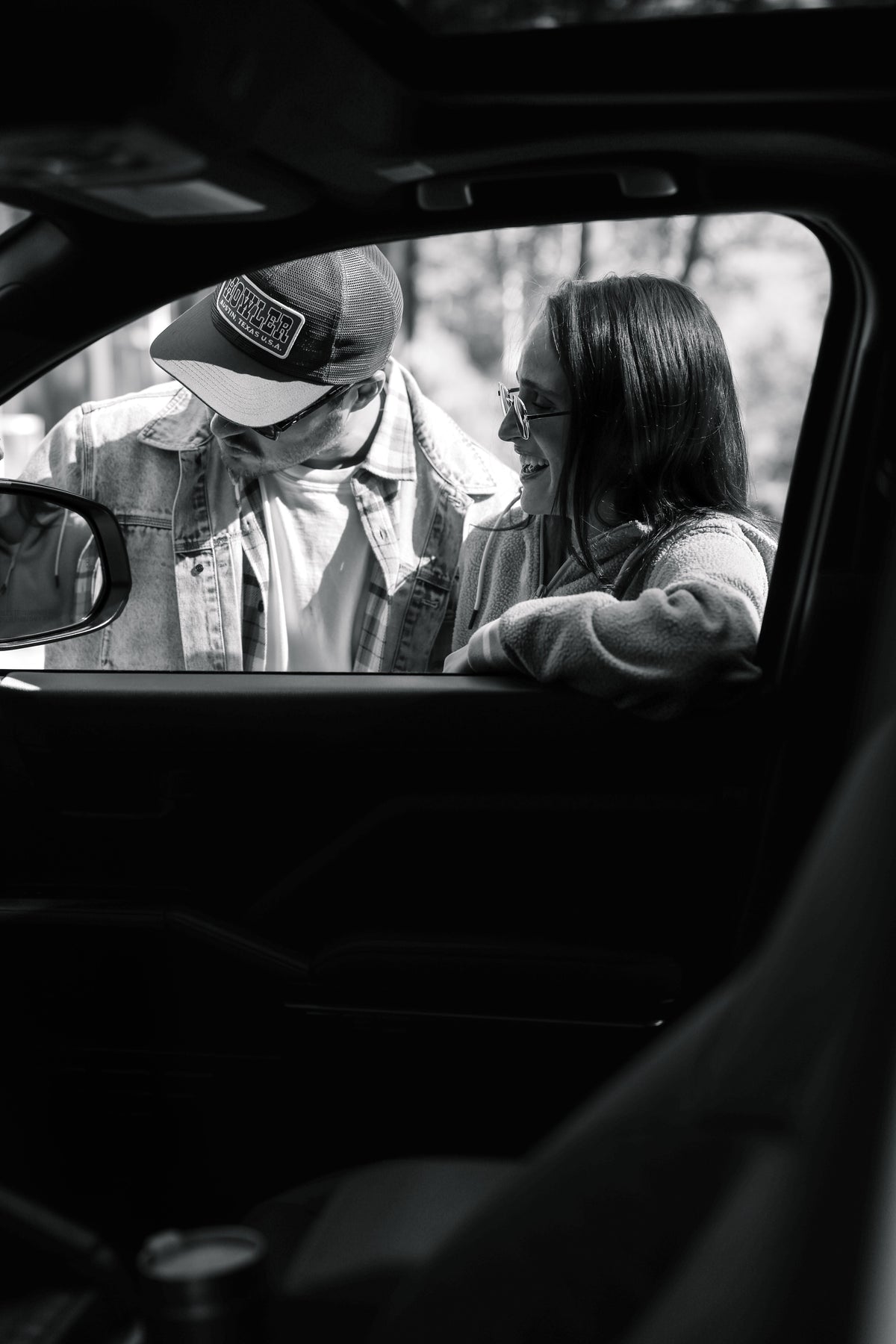 Man and woman viewed from a truck window wearing everyday north styled clothing from Bear Rock