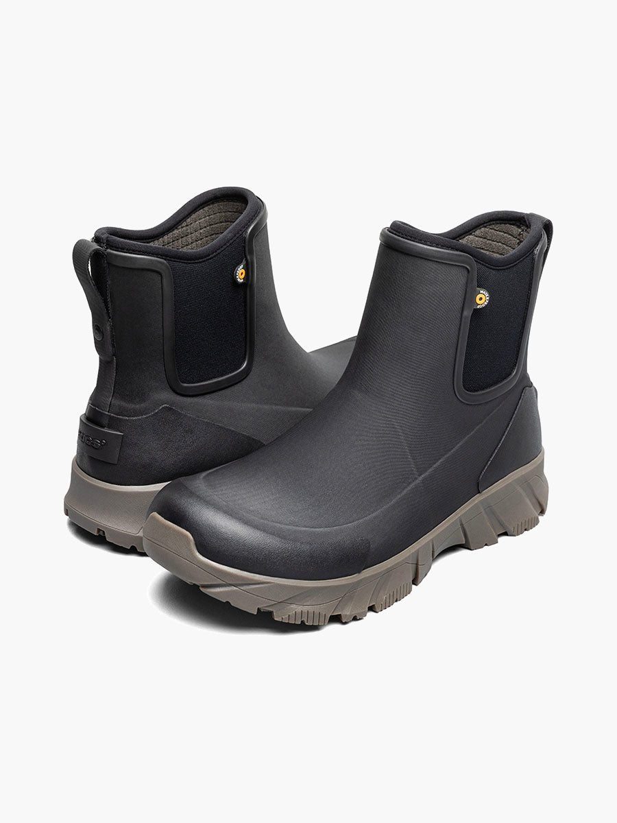 A pair of black rubber Chelsea-style rain boots with gray soles, shown from the side and back on a light gray background.