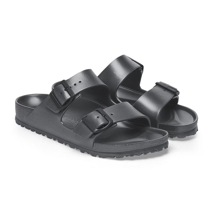 Black sandals with two straps on a white background