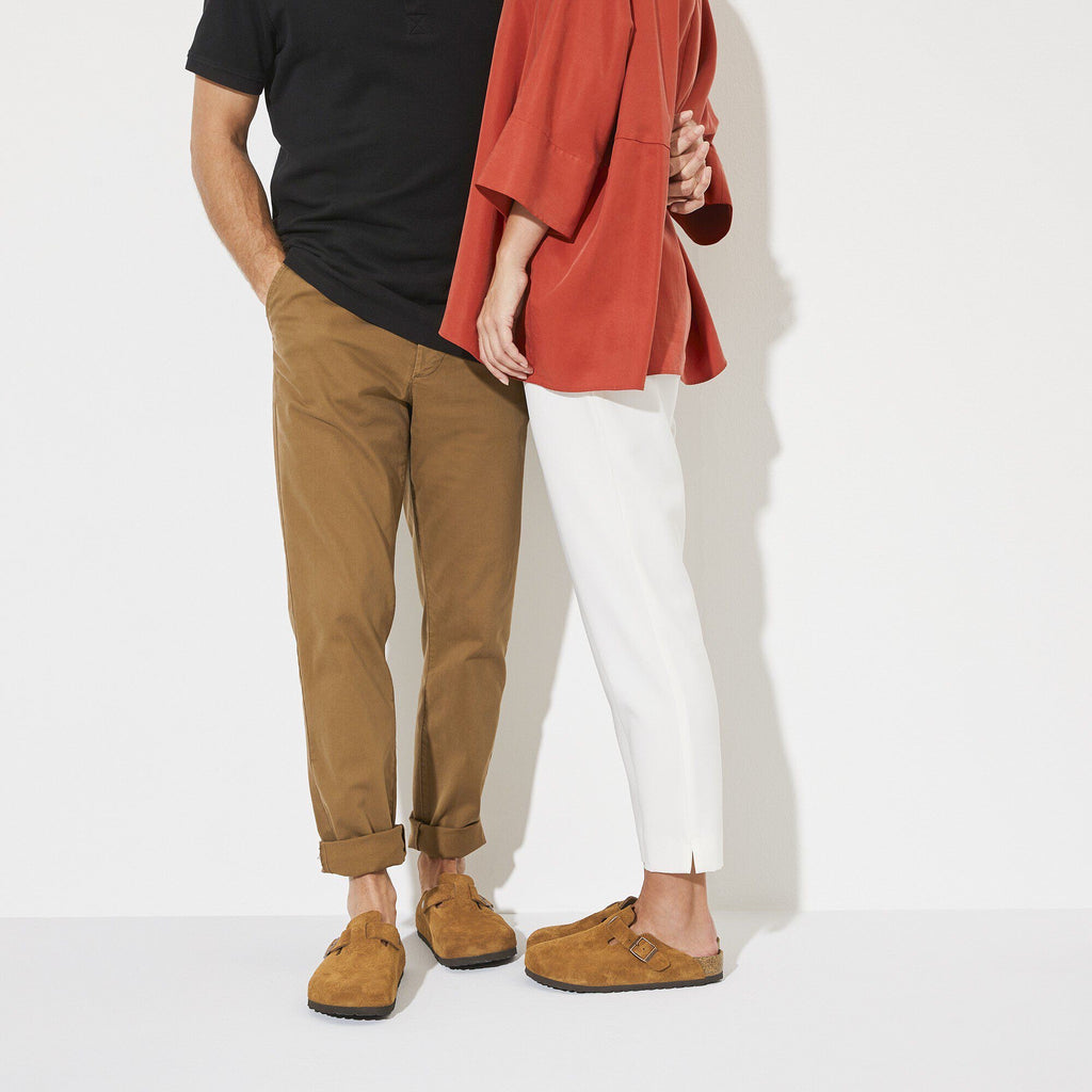 Two people wearing brown shoes on a white background