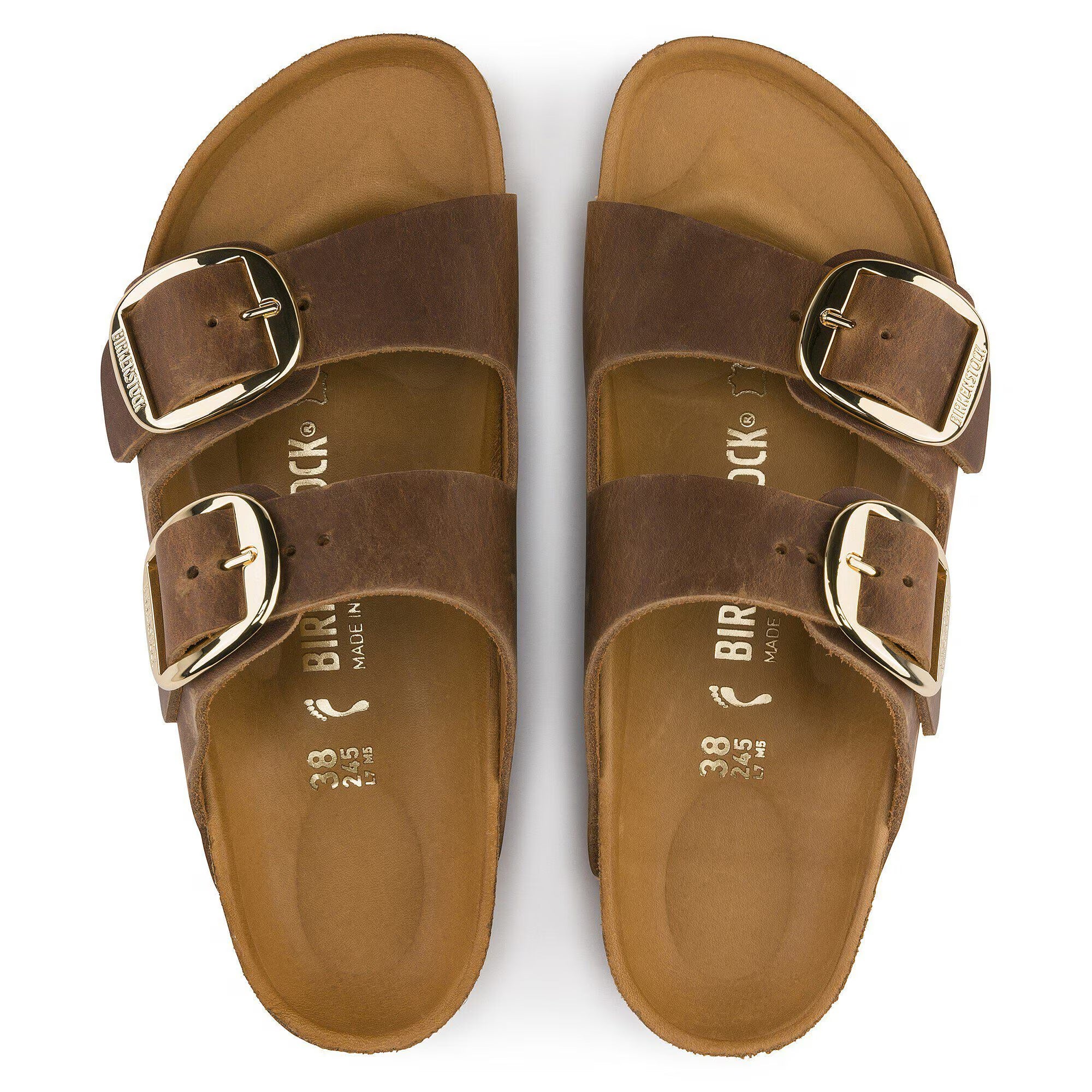 Pair of brown Birkenstock sandals with gold buckles on a white background