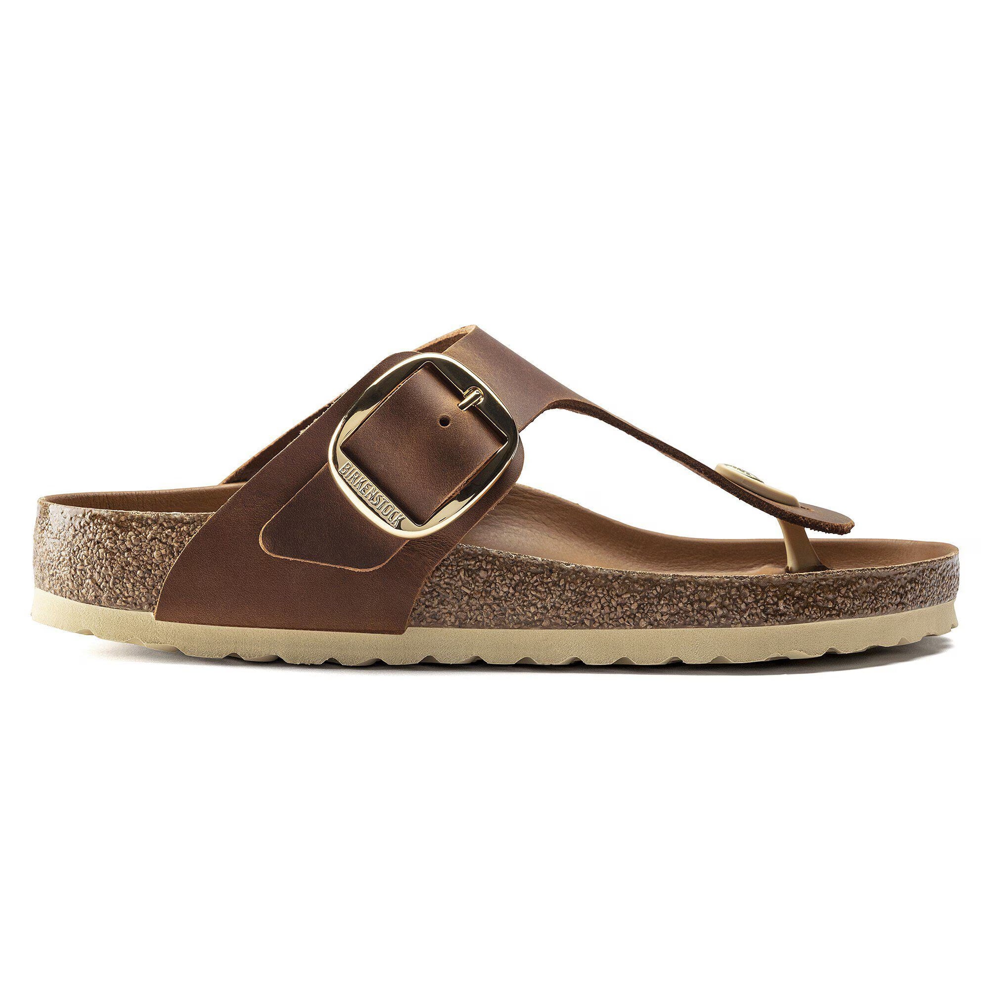 Brown sandal with a gold buckle on a white background