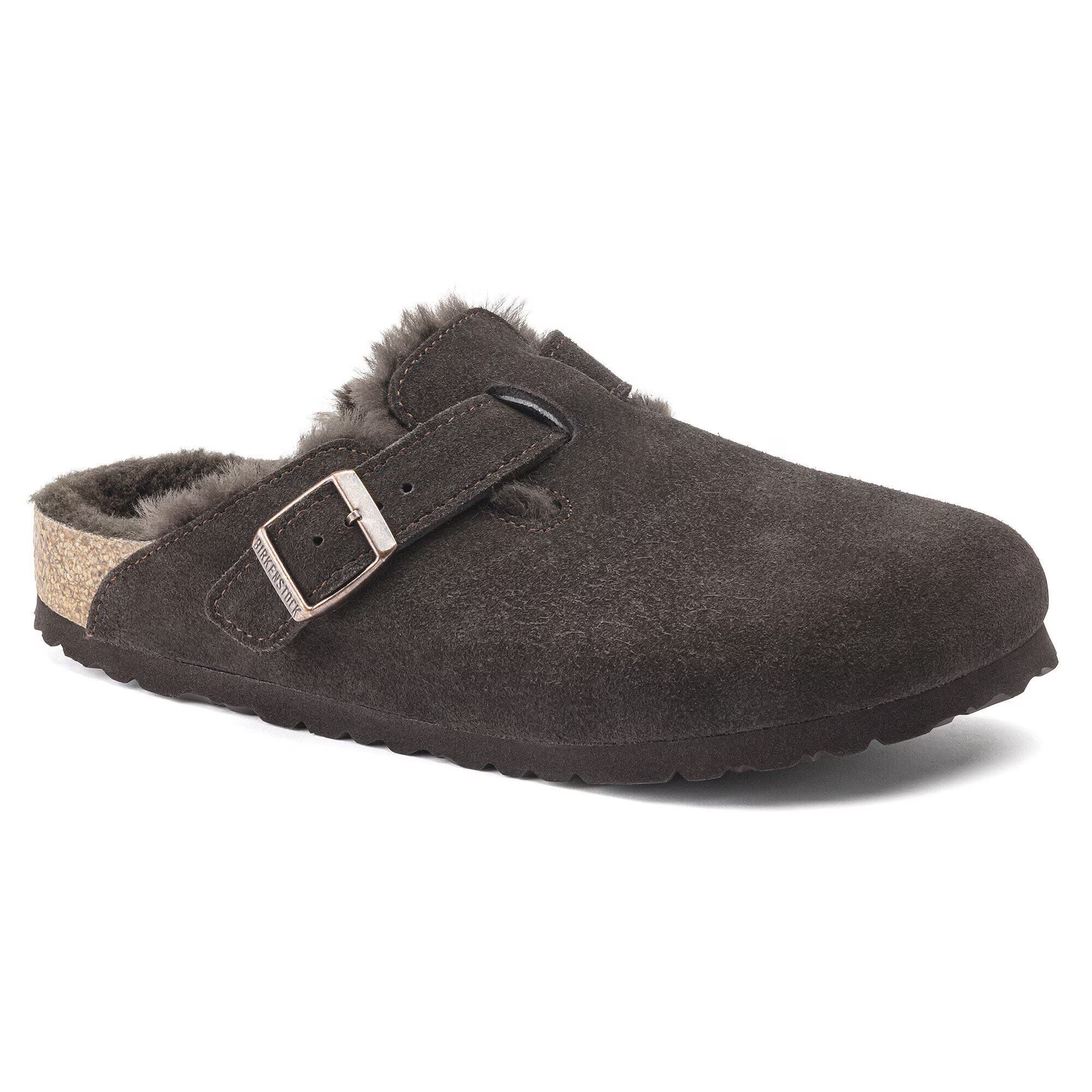 Brown suede slipper with fur lining on a white background