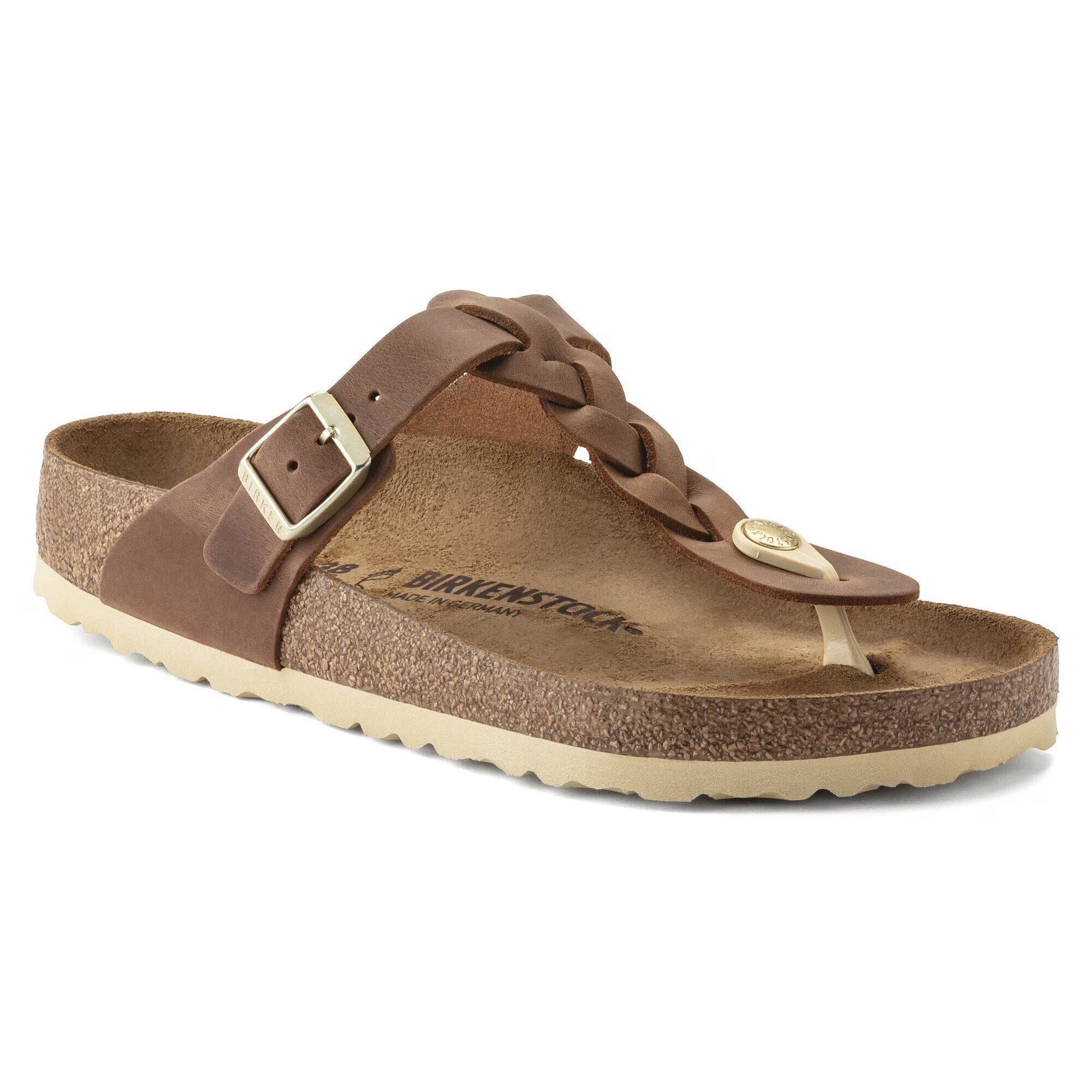 Brown sandal with a strap and buckle on a white background