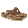 Pair of brown sandals with straps on a white background