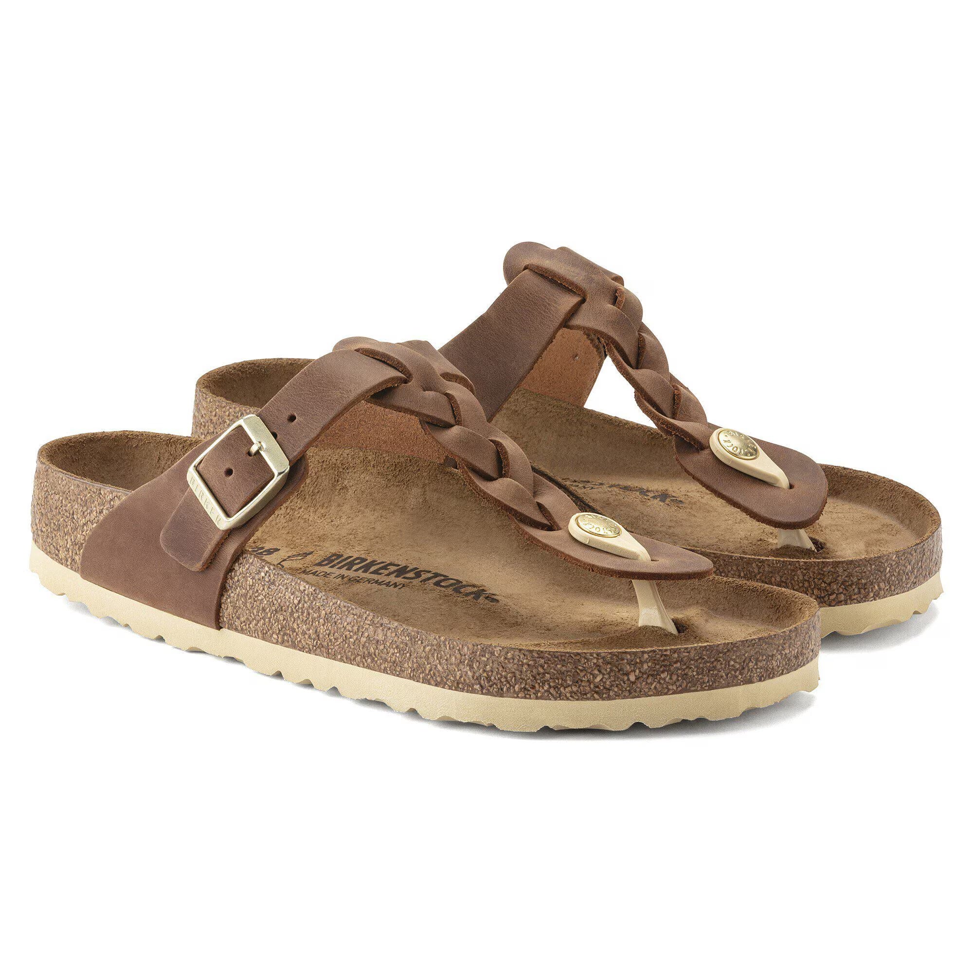 Pair of brown sandals with straps on a white background