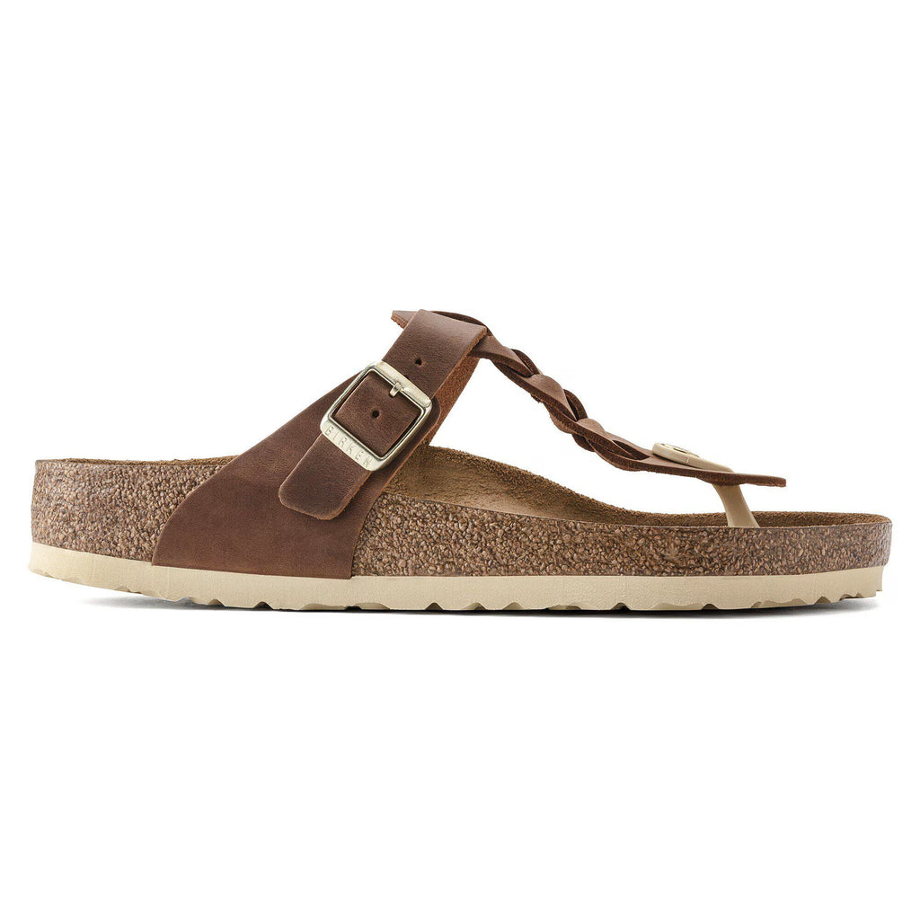 Brown sandal with a strap and buckle on a white background