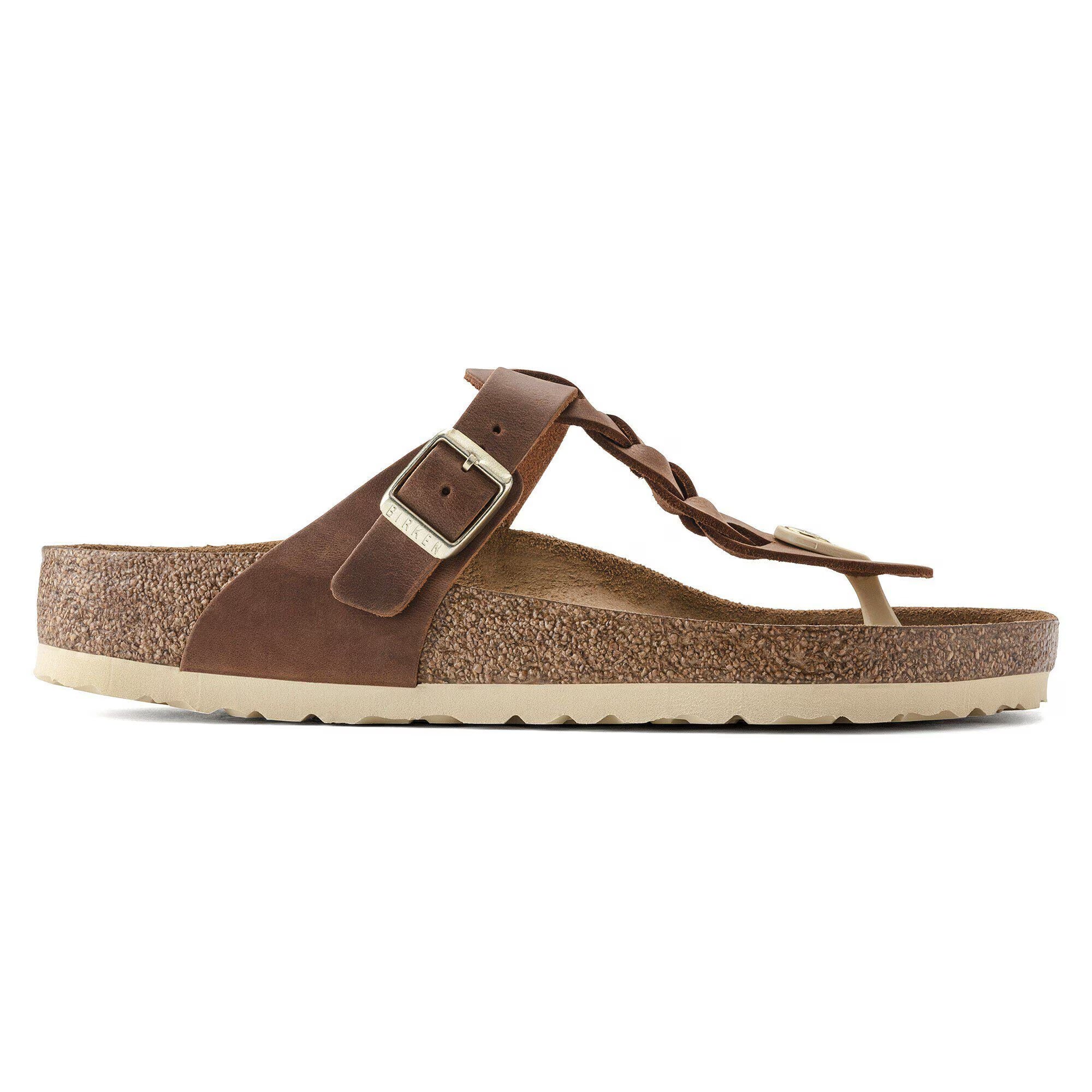 Brown sandal with a strap and buckle on a white background