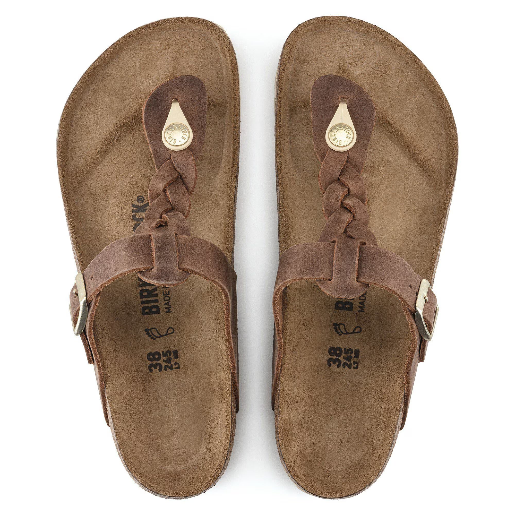 Pair of brown sandals with braided straps on a white background