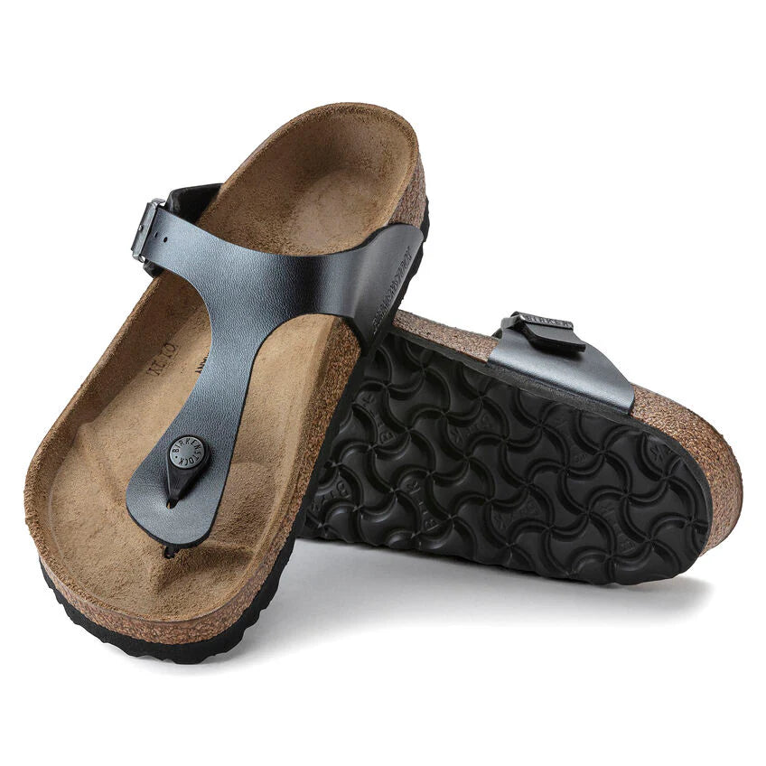 Pair of sandals with brown soles and black straps on a white background