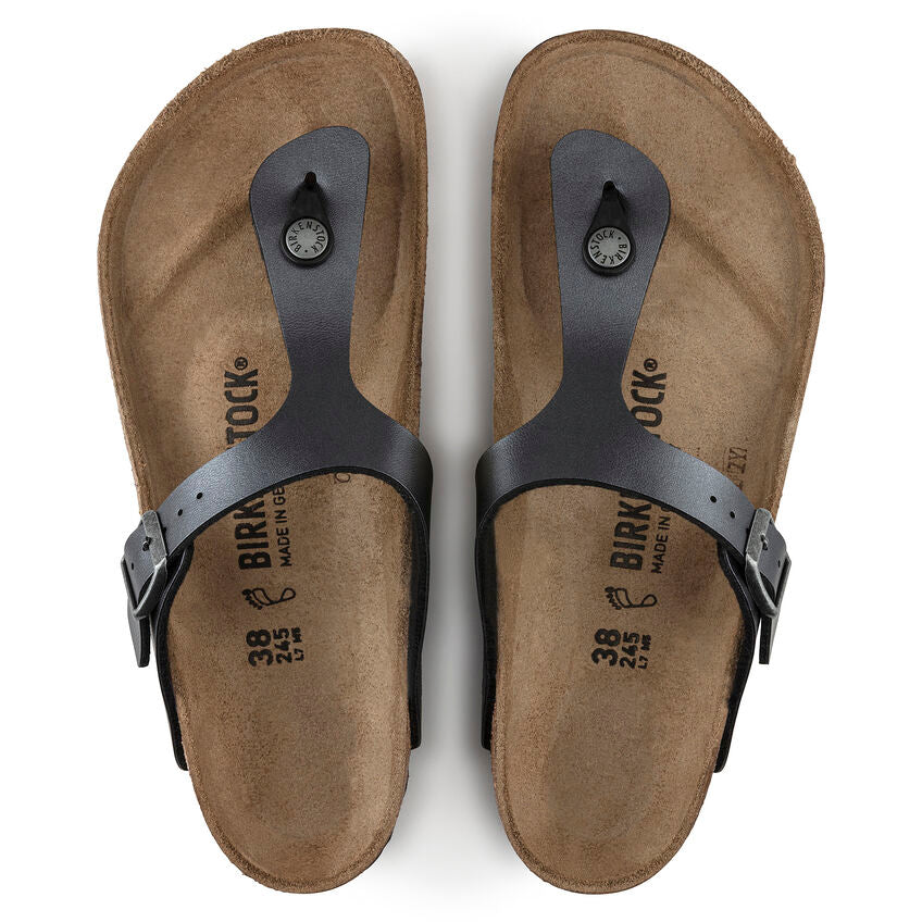 Pair of brown sandals with black straps on a white background