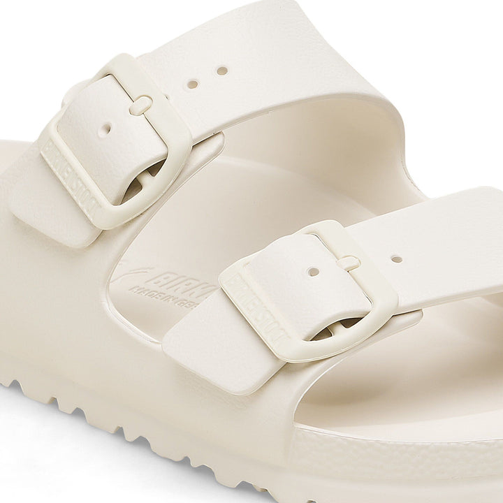 Beige sandal with a strap on a light gray background