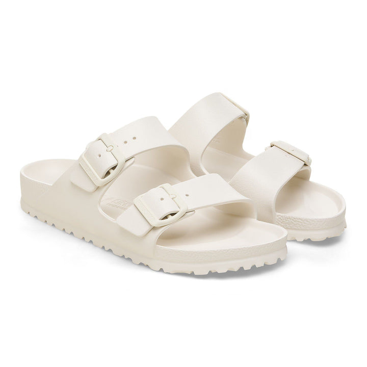 Pair of cream-colored sandals on a white background