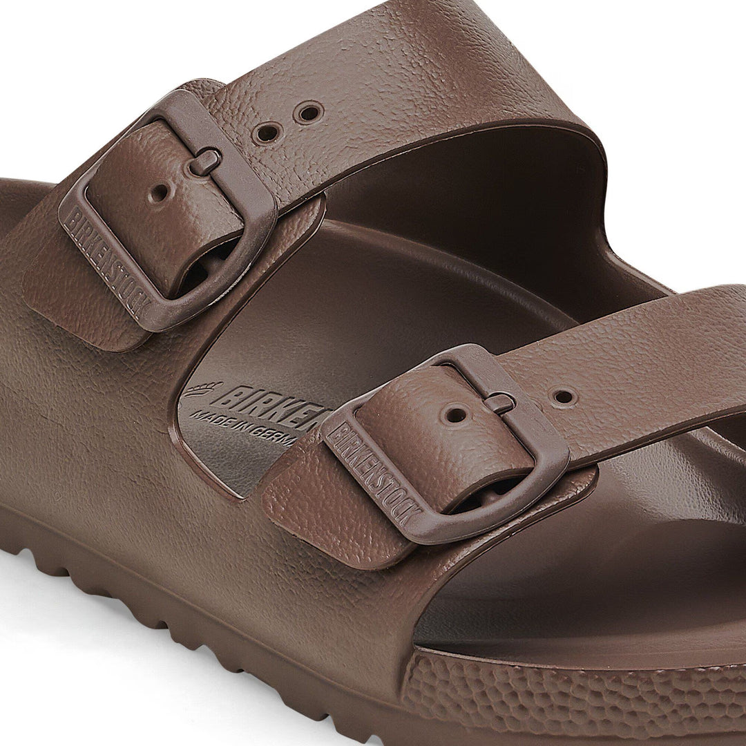 Brown sandal with double buckle strap on a white background