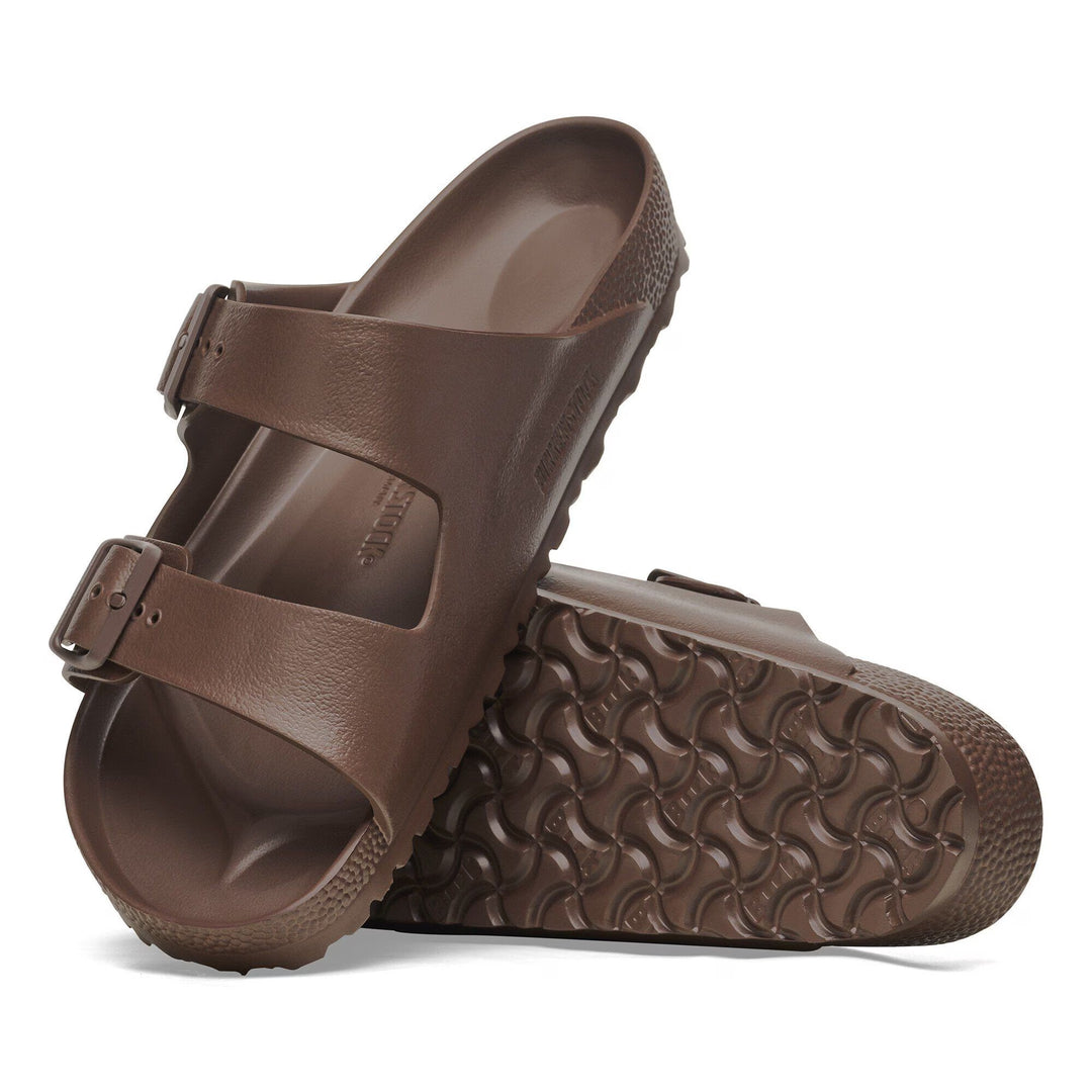 Brown sandals with a textured sole on a white background