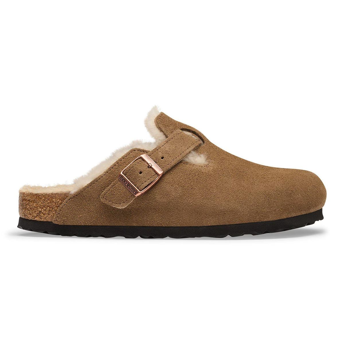 A single brown suede clog slipper with a warm beige shearling lining and a rose gold buckle strap, shown in profile against a white background.
