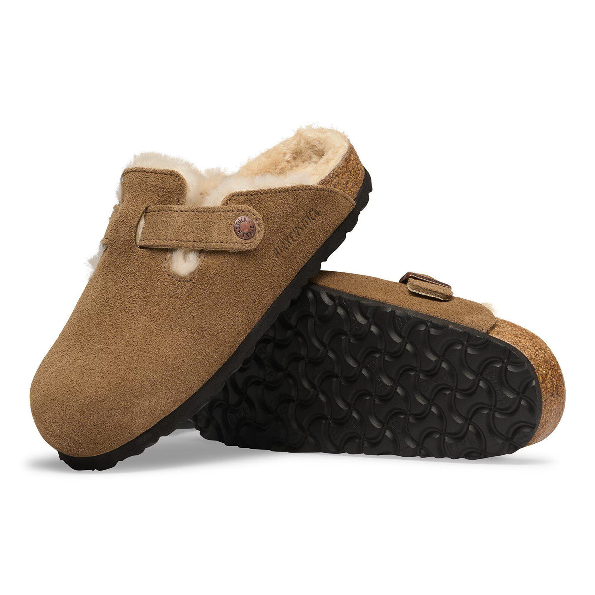 Brown slippers with shearling lining on a white background