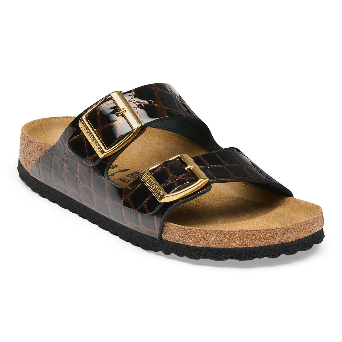 Brown sandal with gold buckle on a white background