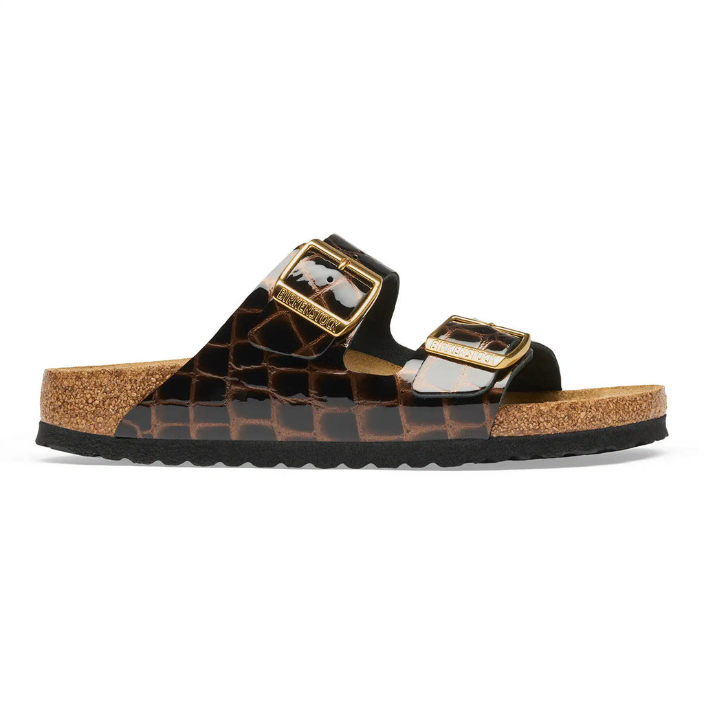 Brown sandal with gold buckle on a white background