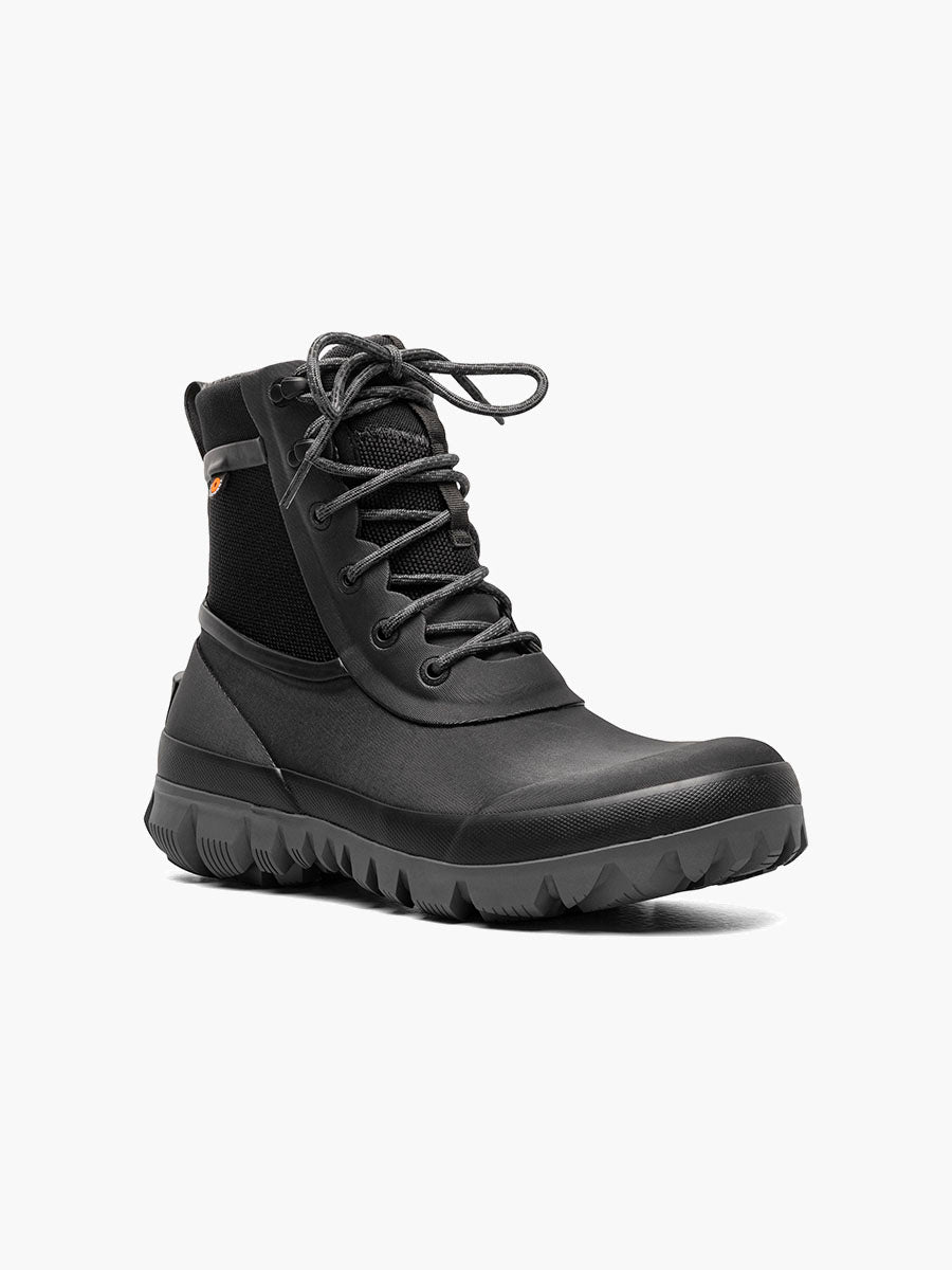 Black boot with a thick sole on a white background