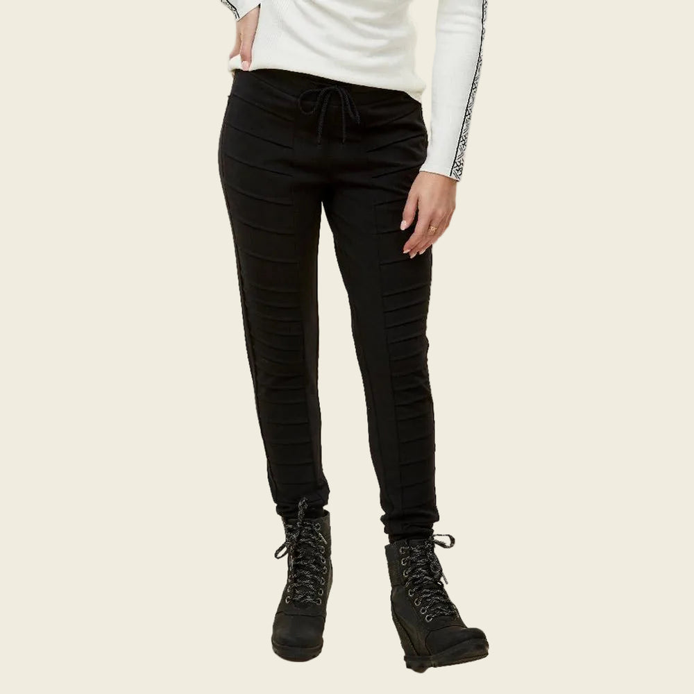 Person wearing black pants and black boots on a white background