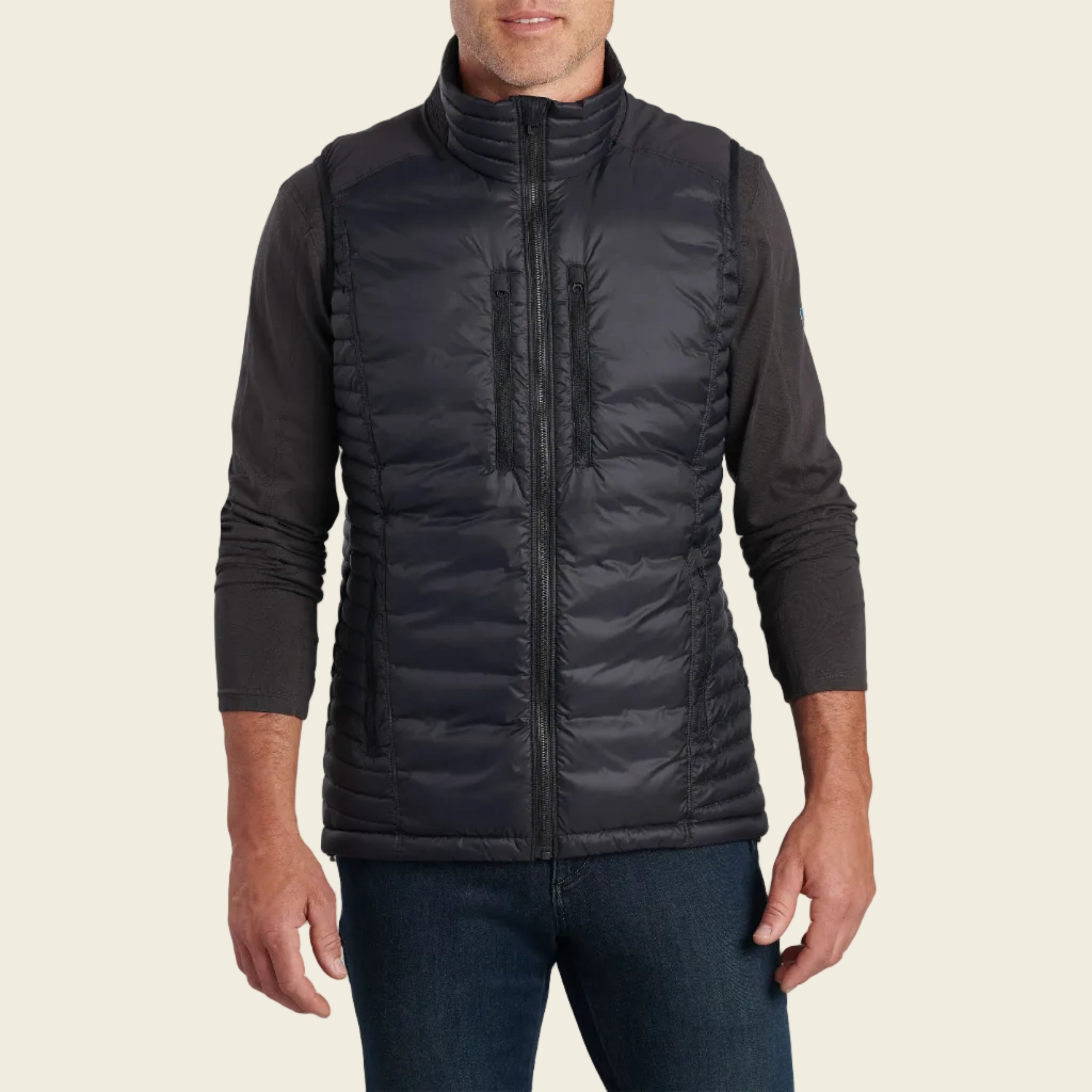 Man wearing a black puffer vest on a white background