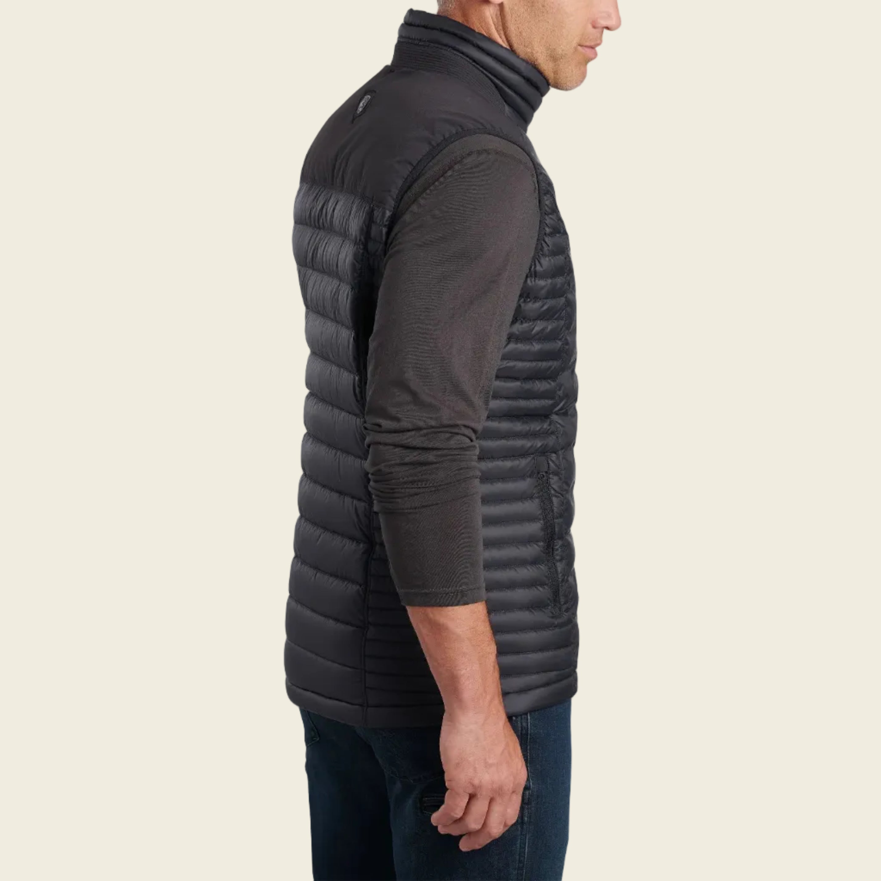 Man wearing a black puffer vest on a white background