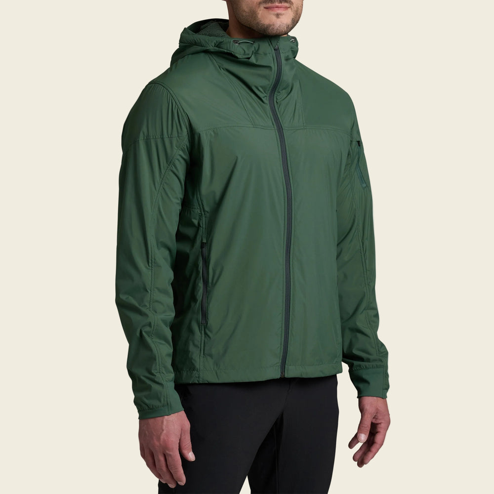 Green rain jacket worn by a person on a white background
