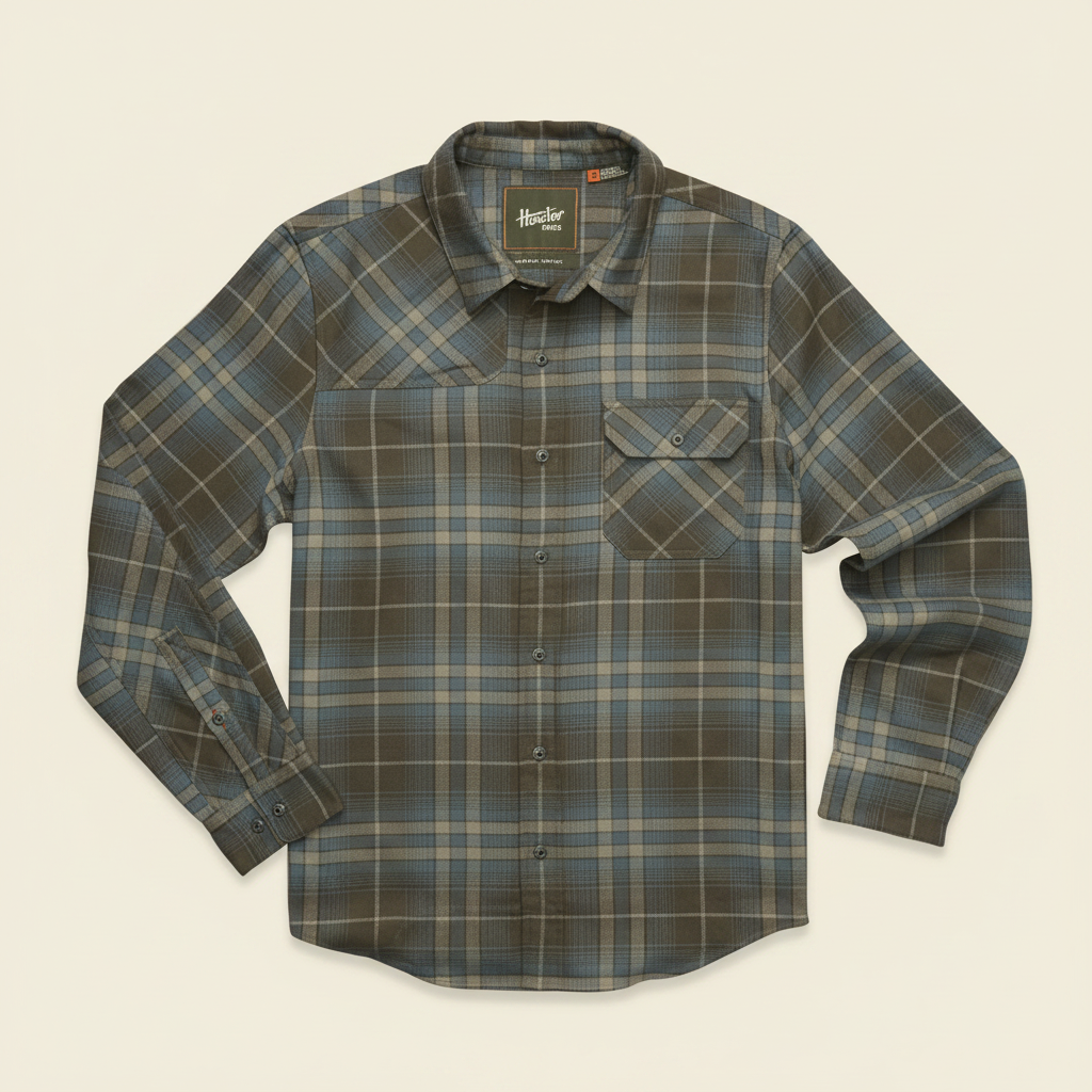 A long-sleeve plaid button-up shirt by Timberland, featuring a muted green, brown, and beige checkered pattern, laid flat against a white background.