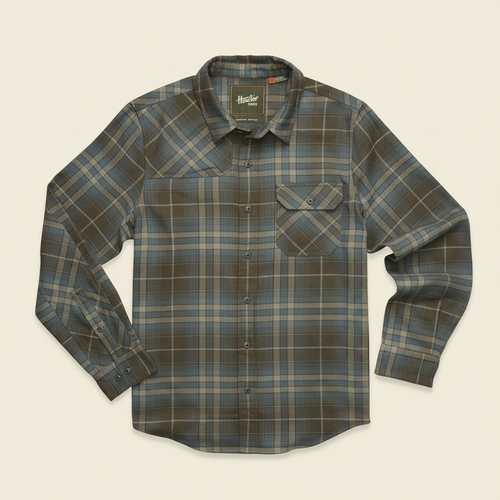 A long-sleeve plaid button-up shirt by Timberland, featuring a muted green, brown, and beige checkered pattern, laid flat against a white background.