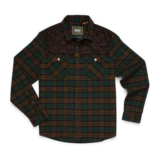 A long-sleeve button-up flannel shirt by Barbour, featuring a dark green and brown plaid body, a solid dark brown quilted yoke, and two buttoned chest pockets.