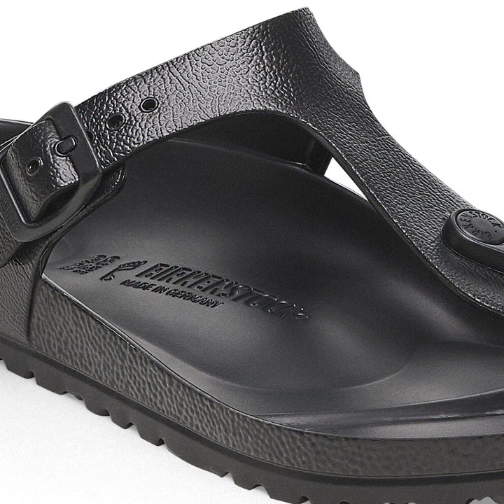 Black sandal with strap and visible brand logo on a white background