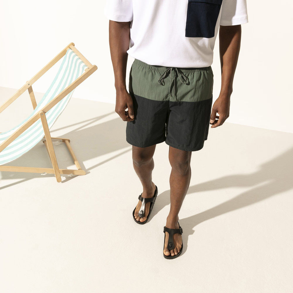 Person wearing a two-tone shorts with a white background