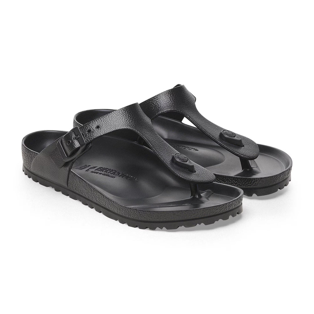 Black sandals with a visible brand logo on a white background