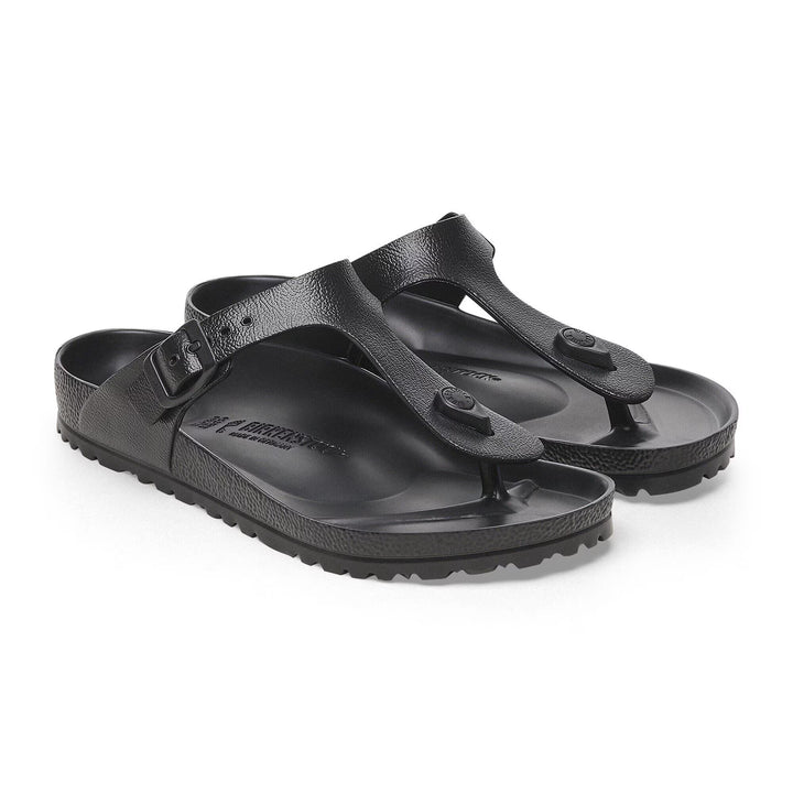 Black sandals with a visible brand logo on a white background