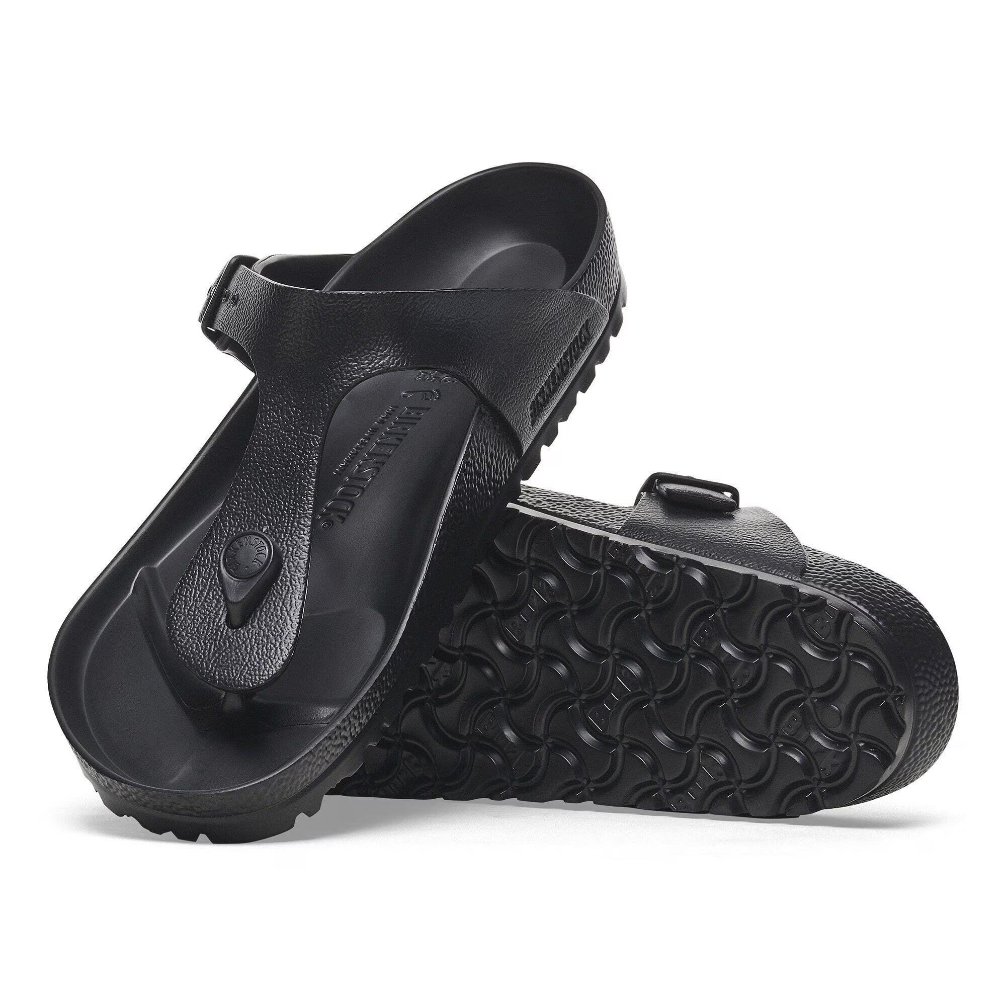 Black sandals with a textured sole on a white background