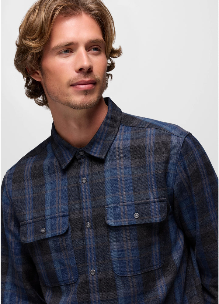Man wearing a blue plaid shirt against a plain background