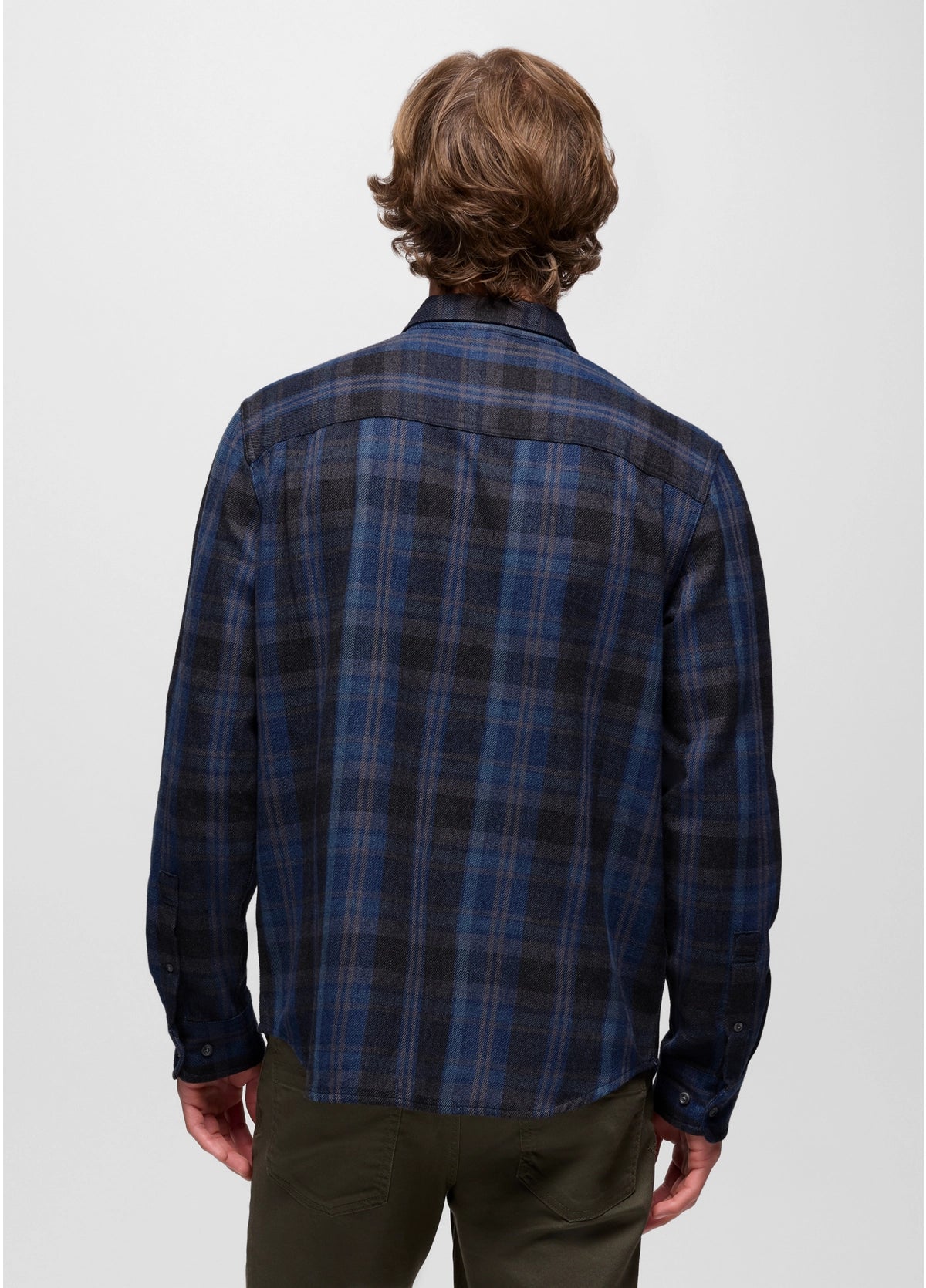 Person wearing a blue plaid shirt on a white background