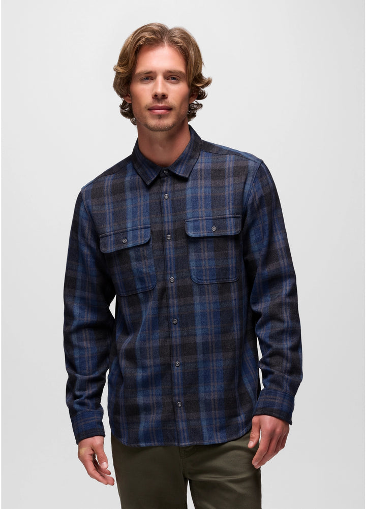 Man wearing a blue plaid shirt against a plain background