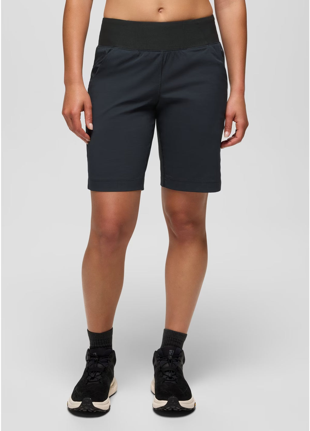 Person wearing black athletic shorts on a white background
