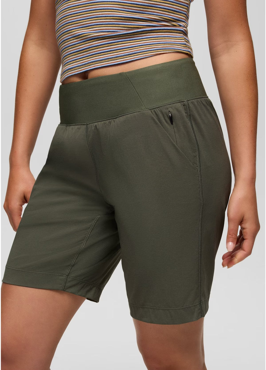 Person wearing green shorts on a plain background