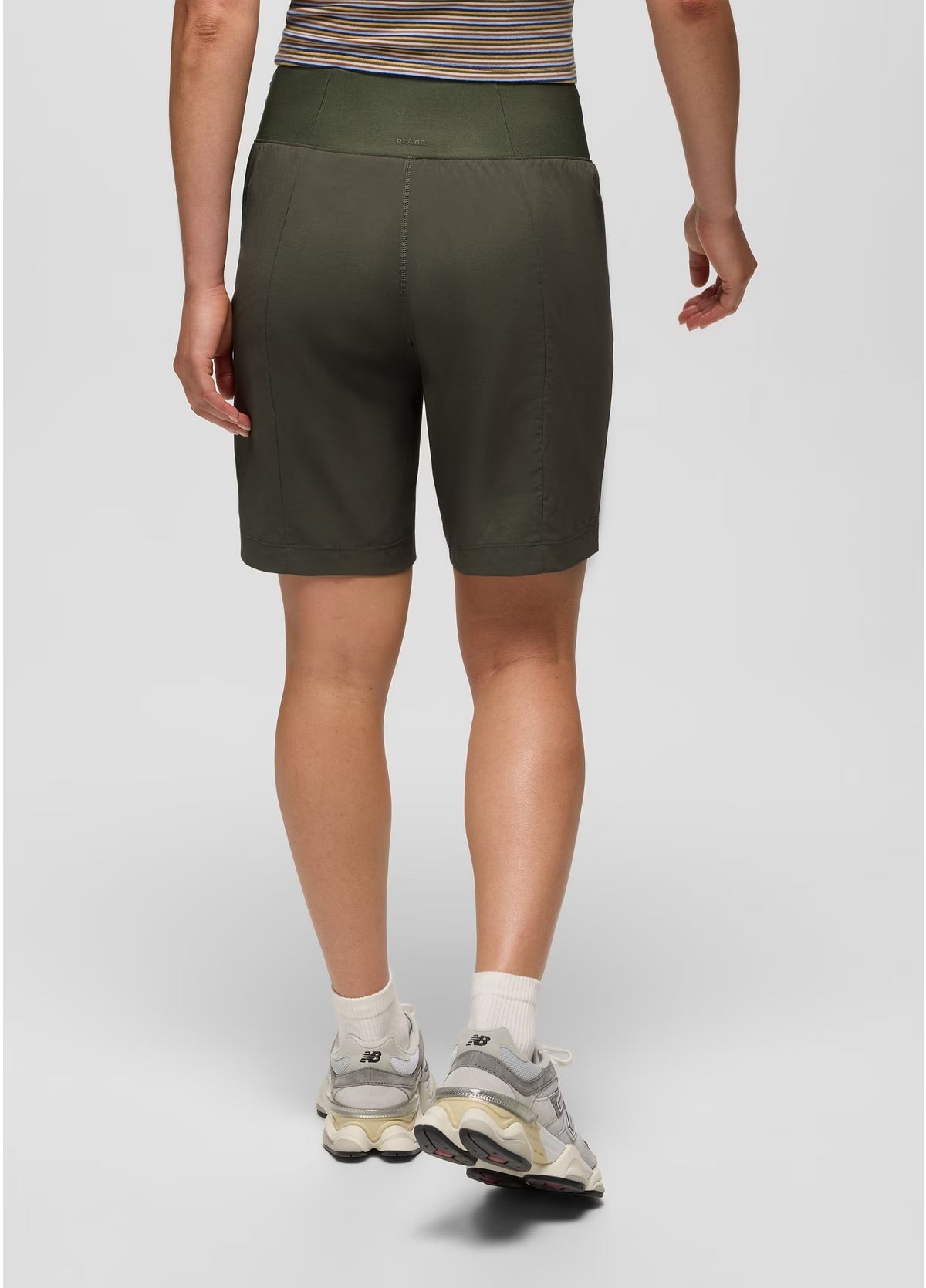 Person wearing green shorts on a plain background