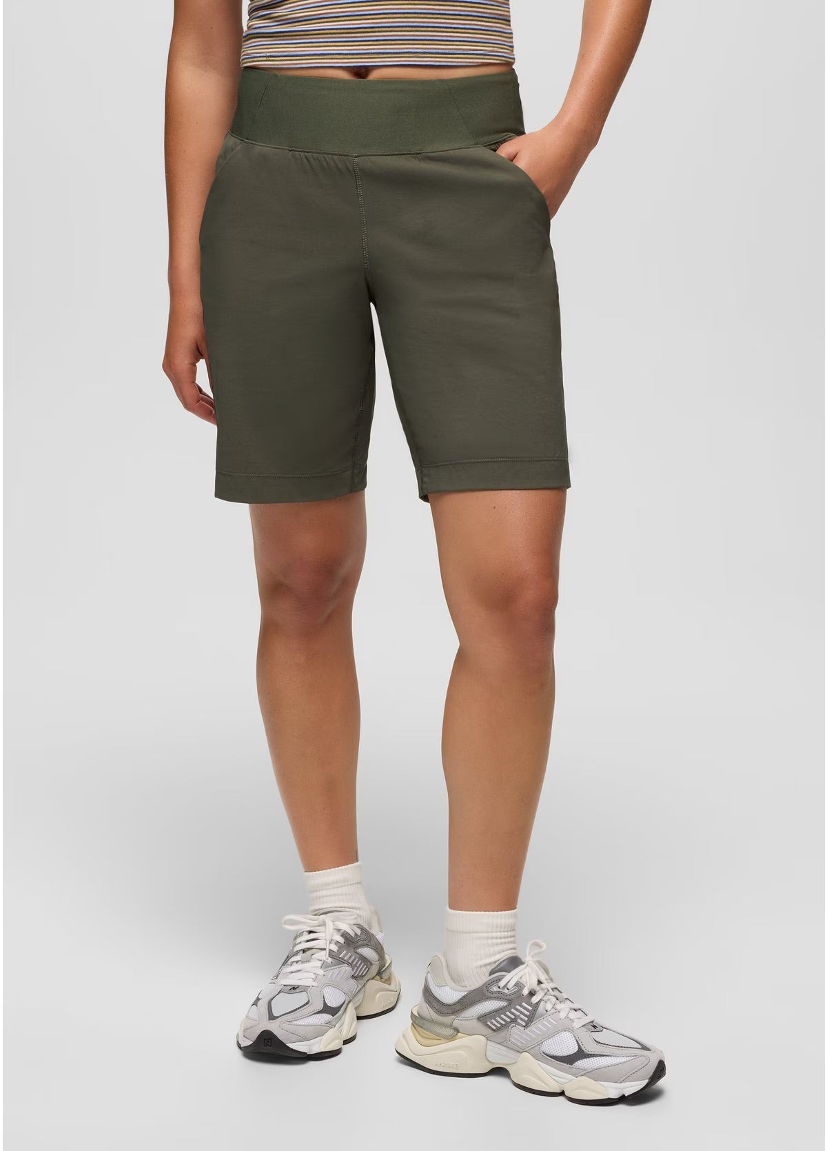 Person wearing green shorts on a plain background