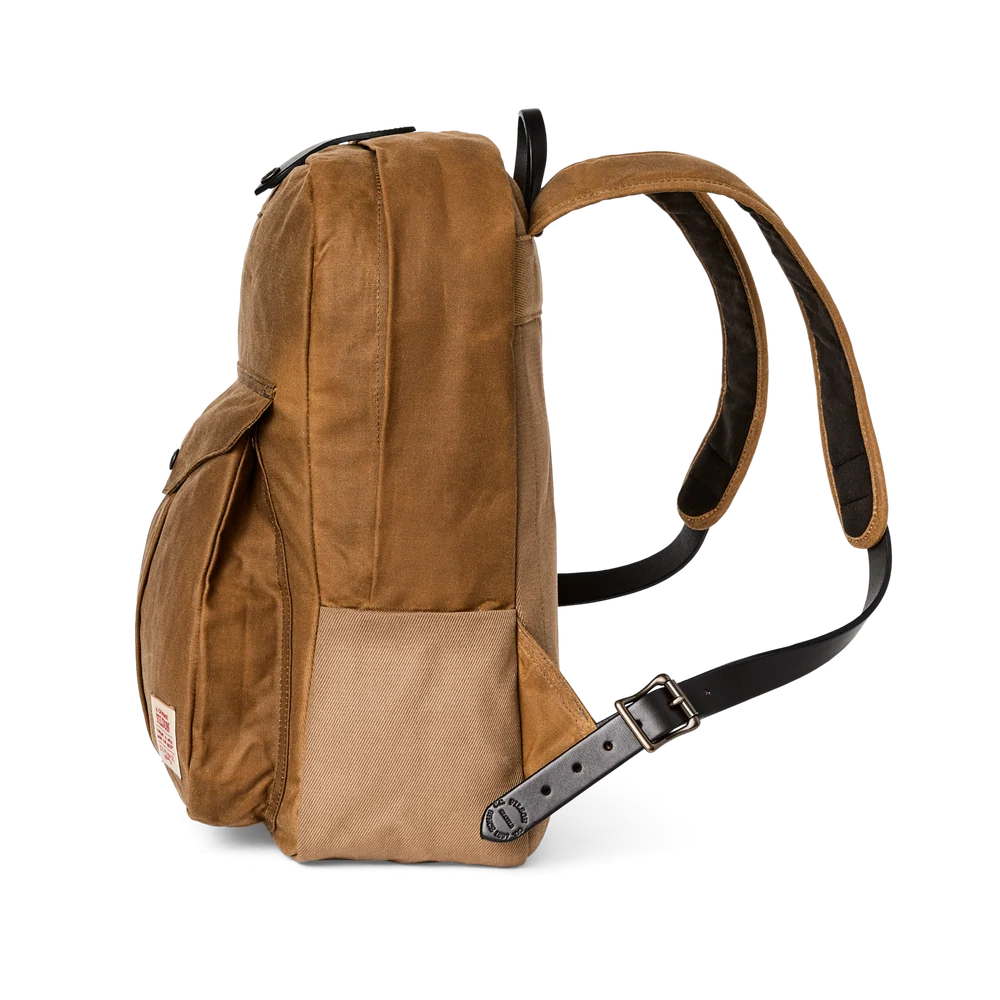 A brown waxed canvas backpack shown from a side profile view against a solid white background, featuring a black adjustable shoulder strap and a silver buckle.