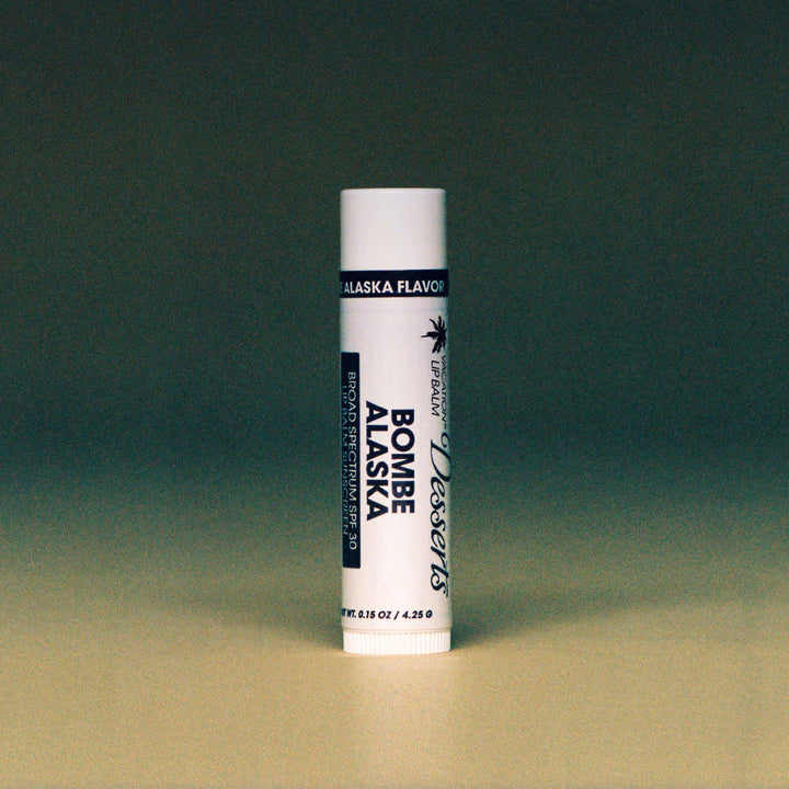 Lip balm tube with 'Alaska Flavor' branding on a gradient background