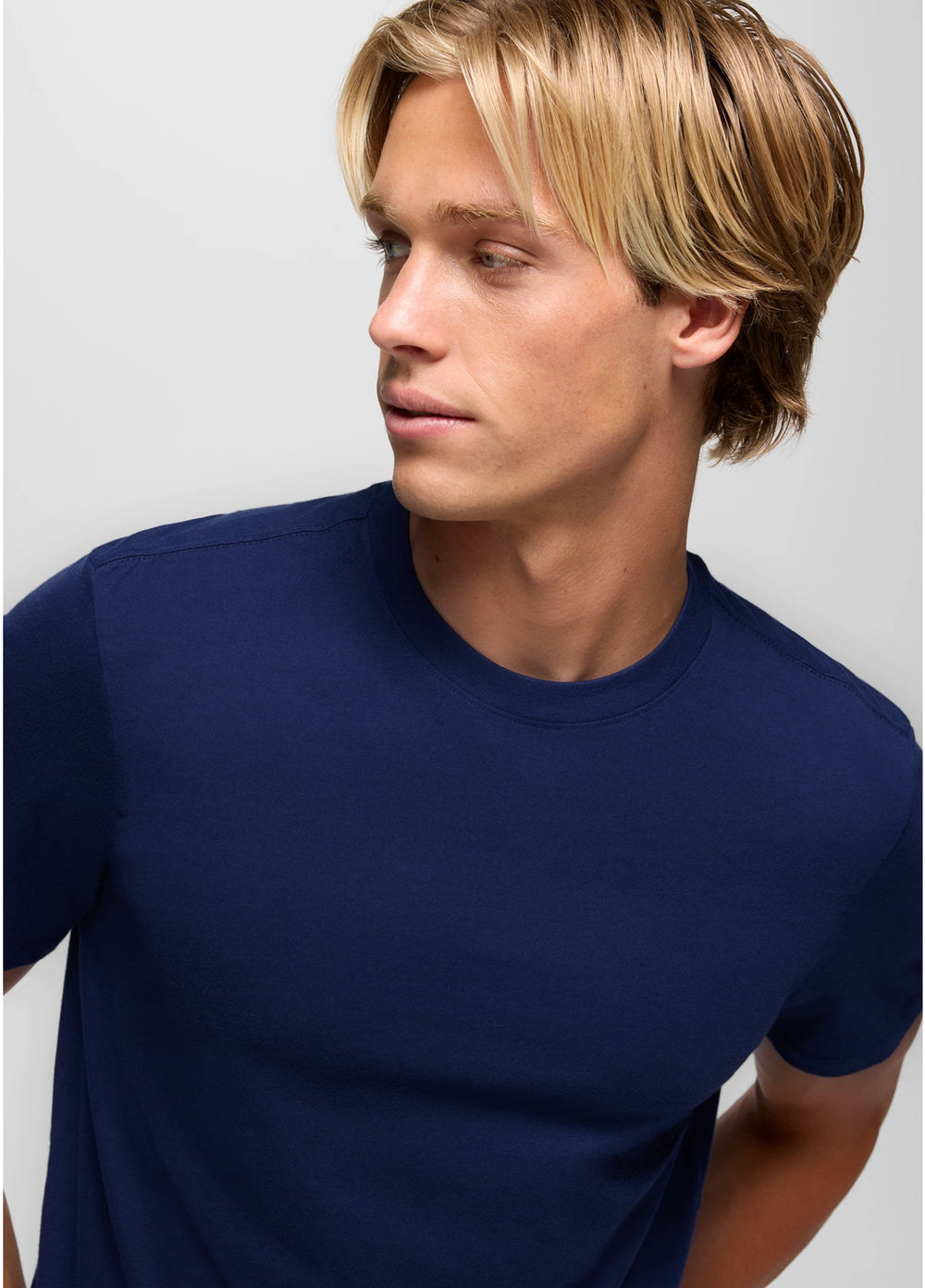 Man wearing a navy blue t-shirt against a plain background