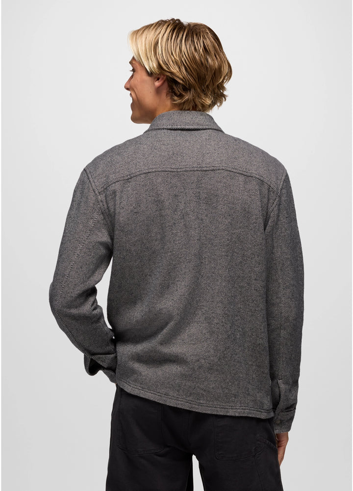 Person wearing a gray fleece jacket on a plain background