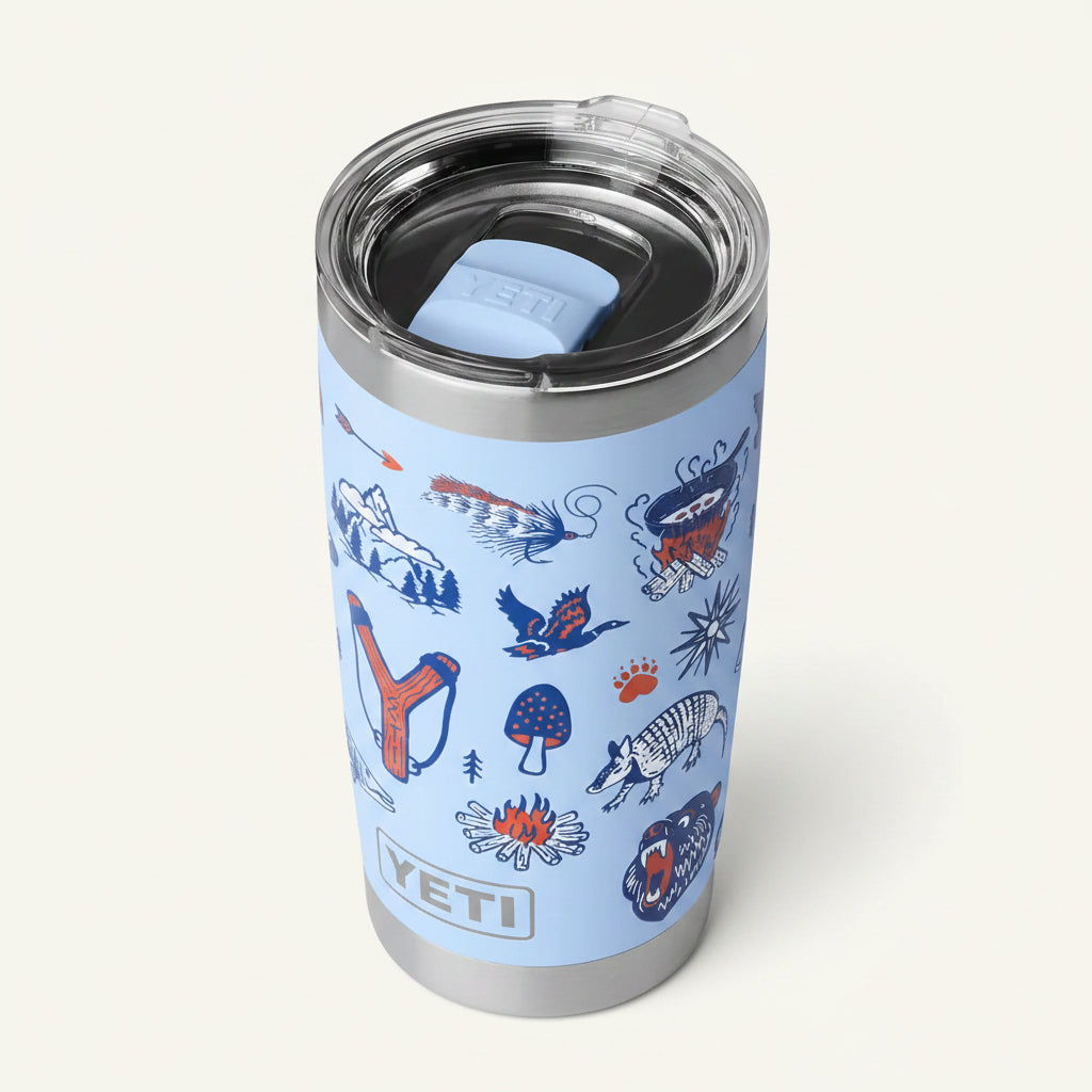YETI tumbler with animal illustrations on a light blue background